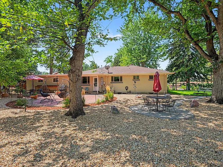 Newly xeriscaped backyard with extra dining area under the mature trees