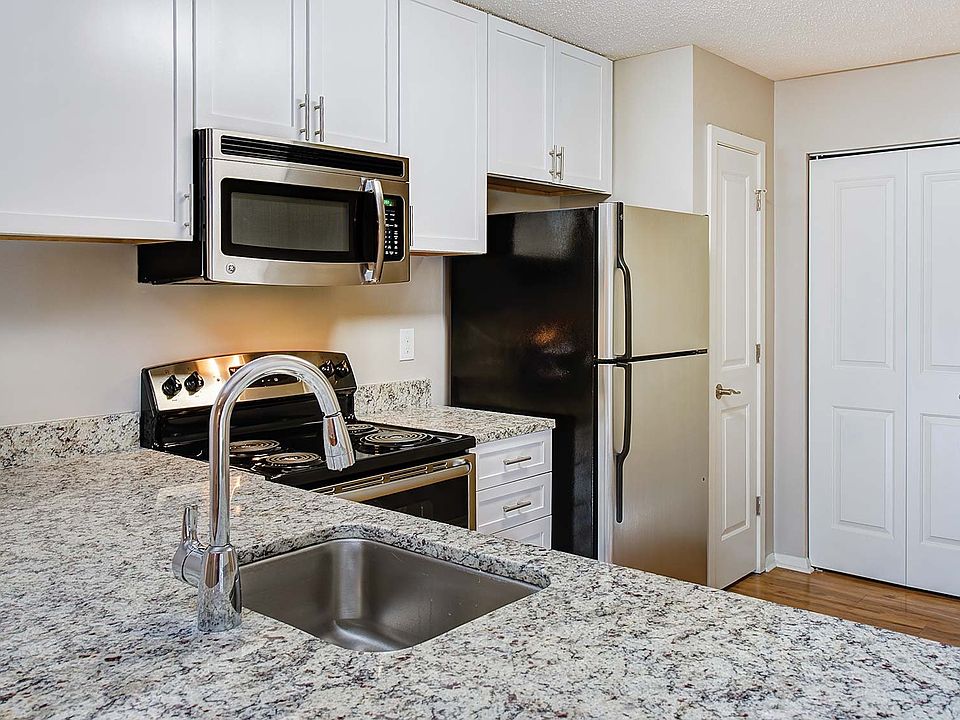 Modern kitchens include granite countertops and GE Clean Steel appliances