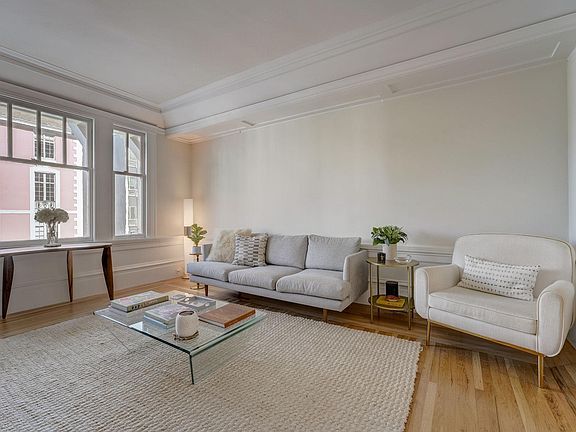Grand but cozy living room overlooking Vallejo Street with soaring 12 ft ceilings and beautiful hardwood floors. There are also pocket doors from the living room to the dining room to close this room off, if needed.