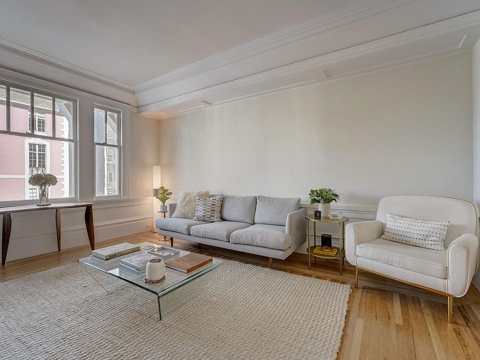 Grand but cozy living room overlooking Vallejo Street with soaring 12 ft ceilings and beautiful hardwood floors. There are also pocket doors from the living room to the dining room to close this room off, if needed.