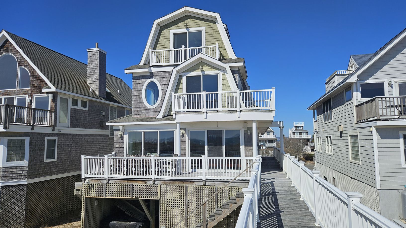  Rear view of house with hot tub and outdoor shower on ground level