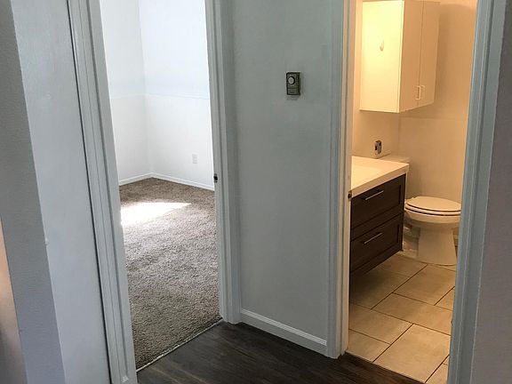 Hallway looking into back bedroom and bathroom