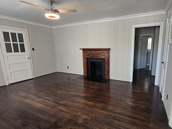 Living Room with fireplace and ceiling fan.