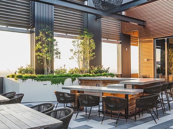 Rooftop courtyard at sunset with ample seating for great entertainment options