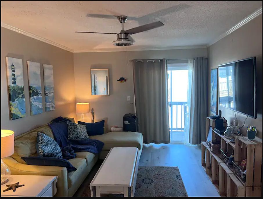 Spacious living room with balcony access.