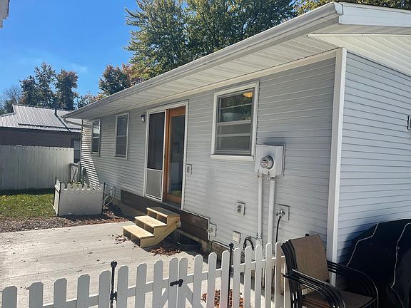 Back door leading to patio in fenced in backyard