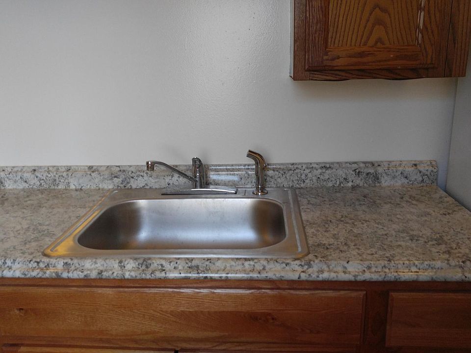Newer kitchen sink, counter, cupboards