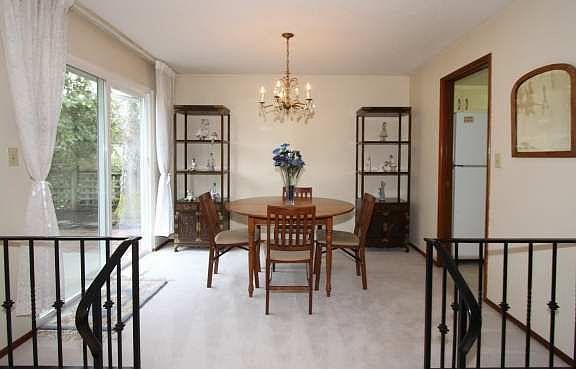 Dining room with double-pane glass sliders out to the private backyard patio.