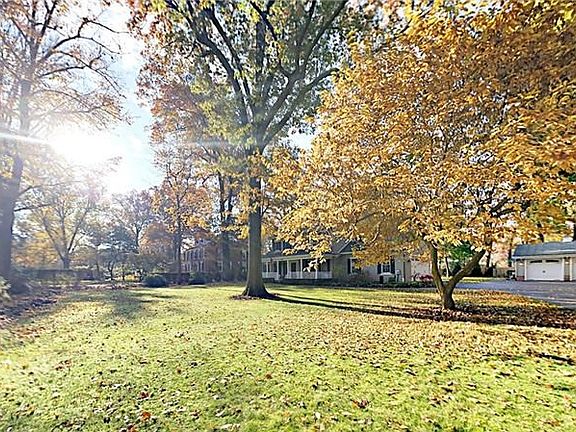 A very private, flat lot with mature trees.  Detached garage to the right is a bonus for cars, storage or hobbies.