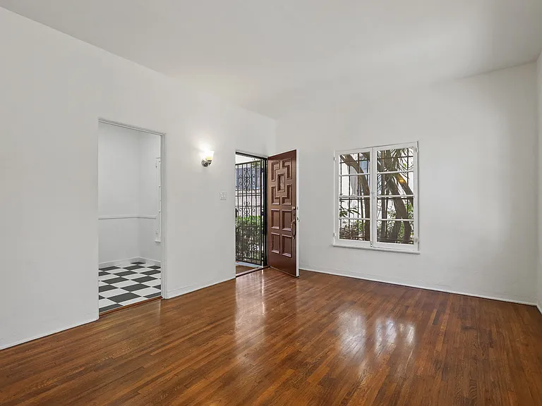 Front Door Entrance into Living Room Area with Hardwood Floors