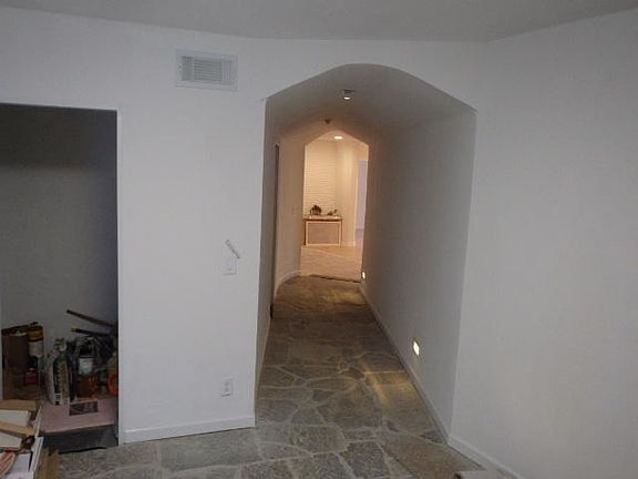 Main level- entry area with stone entry to living area, lighting is motion controlled