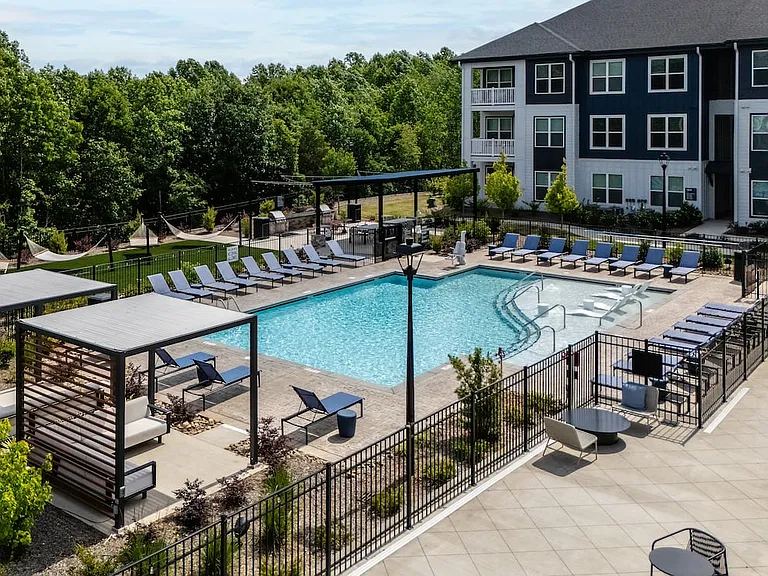 Pool and sundeck with cabanas and hammock lawn