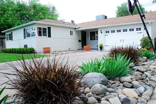 Newly updated exterior features include: roof, HVAC, paint, automatic sprinklers and river rock landscape.