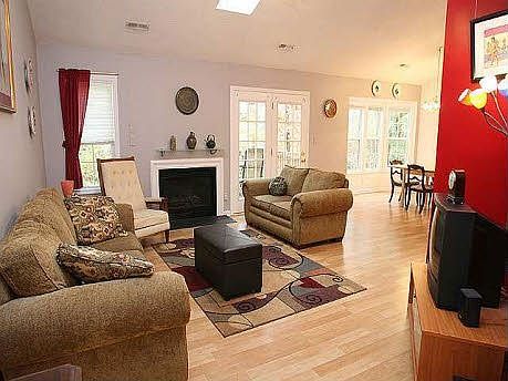 Bright family/great room, with gas-log fireplace, skylight, and bay window