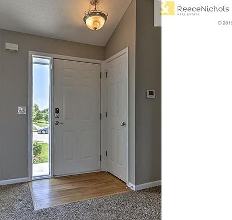 Front door opens to hardwood entry and coat closet.