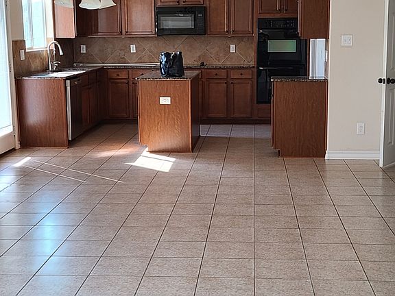 Bright open floor plan. Kitchenhas diswasher, double ovens, range & microwave. Laundry room off to the right, living room w/access to back patio & garage
