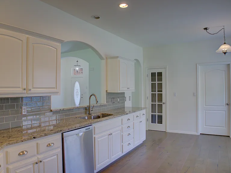 kitchen w/ granite countertops and stainless steel appliances