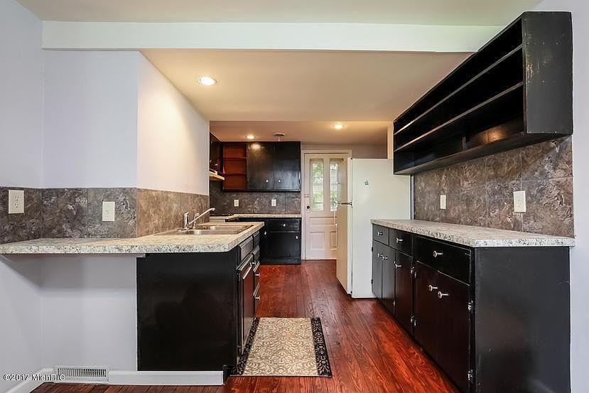 kitchen view, new stainless refrigerator and gas stove have 