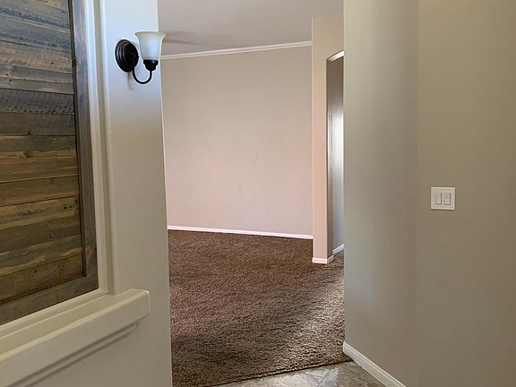 Entry has a great accent wall and new tile.
