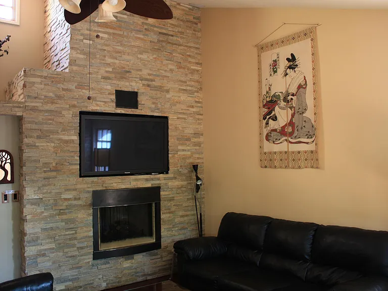 Beautiful stonework with gas fireplace, opening for a TV
