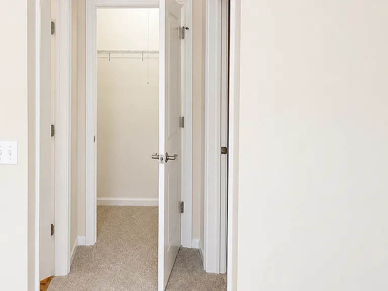 View from the family room toward the coat closet. The powder room is on the left; the laundry room and hallway to the garage are on the right.