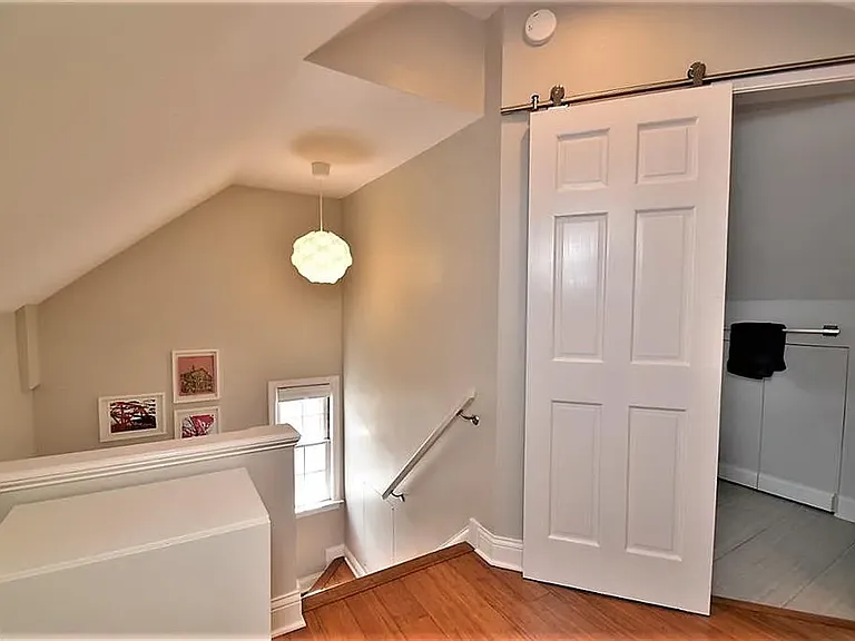 3rd floor looking out from the office nook into the 3rd floor full bathroom to the right and the stairs back down