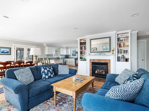 Open floor plan: living room with gas fireplace, dining room, and kitchen. All with views of the ocean.
