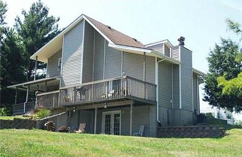 Two large decks (one set up for a hot tub) and a patio.