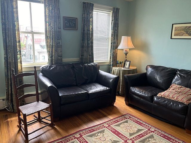 LIVING ROOM WITH 2 COUCHES AND WINDOWS