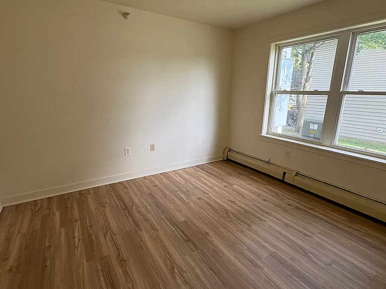 bedroom two. double door closet across from windows.