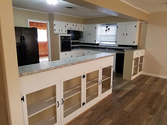 Dining room into kitchen with den behind.