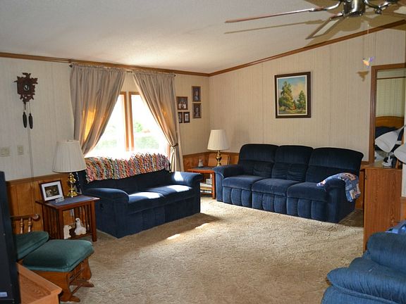 Once inside the open floor plan is in full view.  The living room features vaulted ceilings, a picture window and is completed in neutral colors.