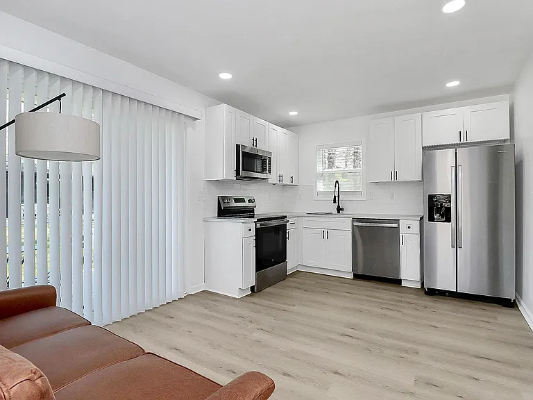 Ample private kitchen with quartz counters and sta
