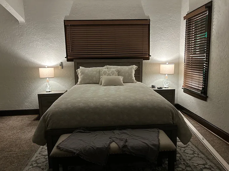 Evening view of your room with bedside table lamps lit creating the perfect ambiance for relation.