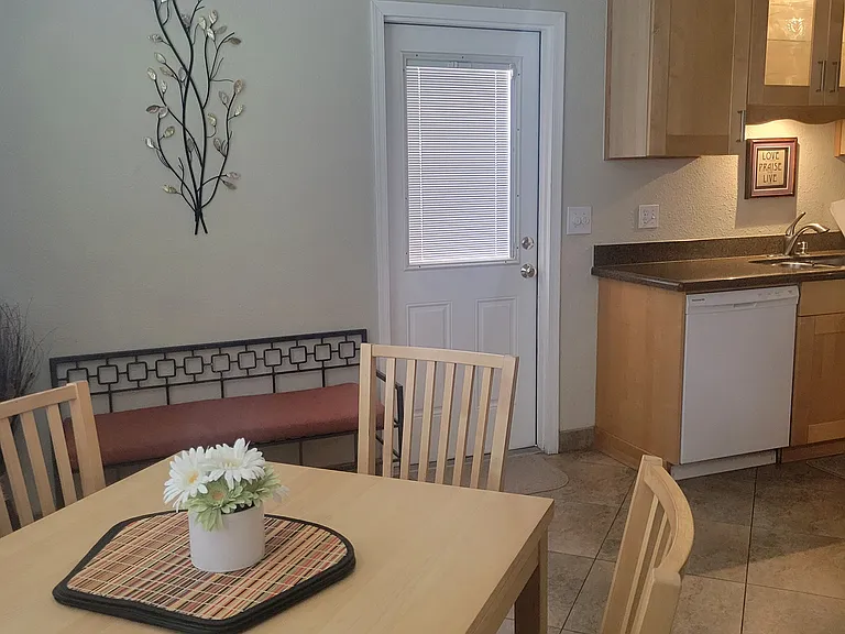 View of kitchen table, which expands to seat 6, just off of the kitchen.