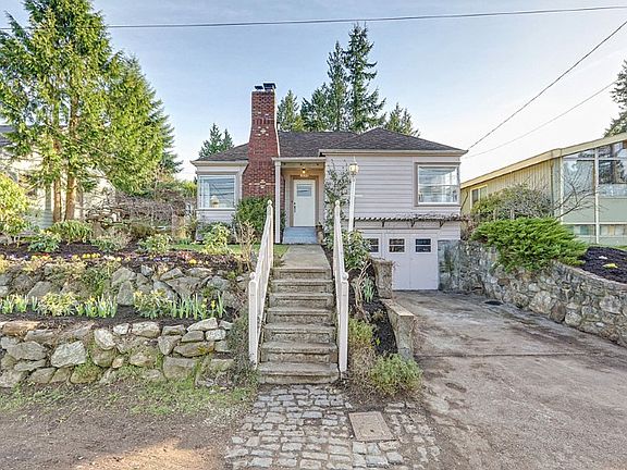 This updated 30's classic sits elevated above a quiet street with level entry to the basement and one car garage.