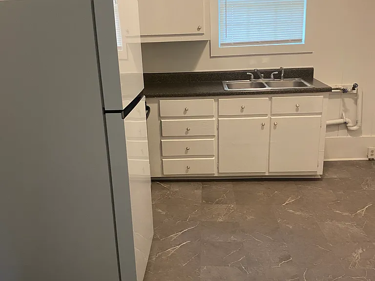 Spacious kitchen with room for a table around the corner.