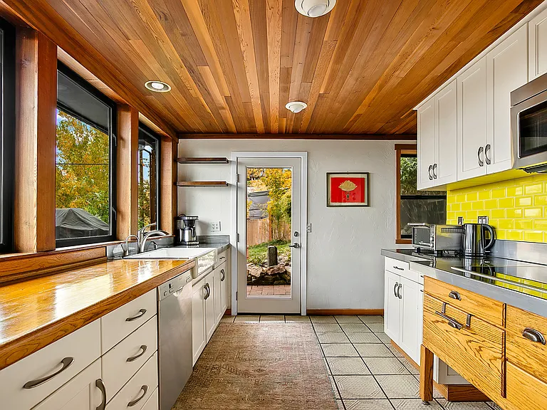 Large kitchen furnished with cookware and dishware as well as various small appliances to create gourmet meals.