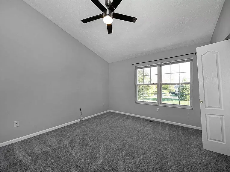 Front bedroom with vaulted ceiling - window view