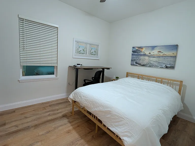 Second of two bedrooms with queen bed, adjustable desk, and ample closet.
