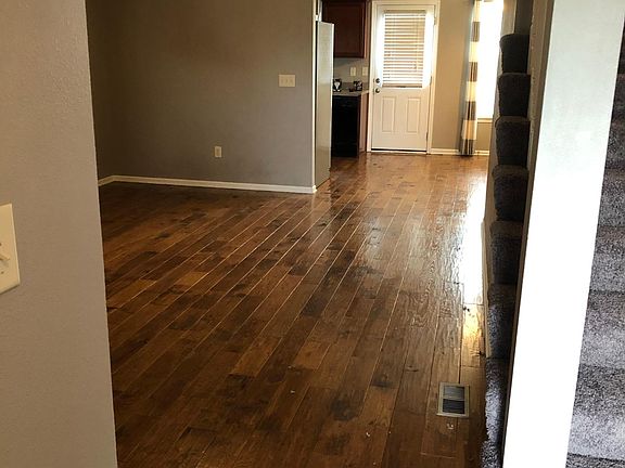 View from entry way. Living room on left. Kitchen and dining in back