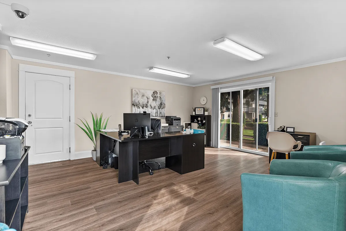 Welcoming leasing office with modern furnishings and natural light. - Trellis on Orchard