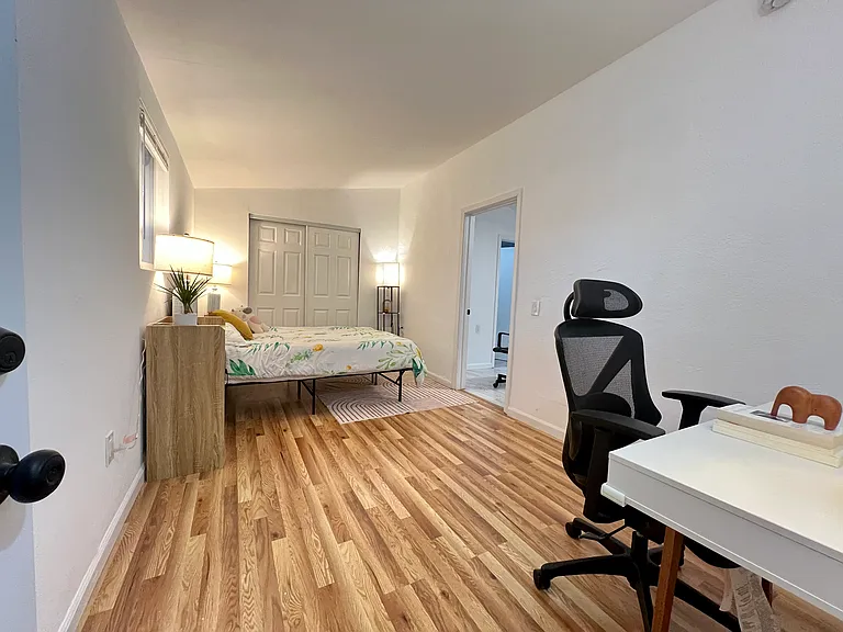 Spacious bedroom with dedicated area for work desk and work-from-home setup