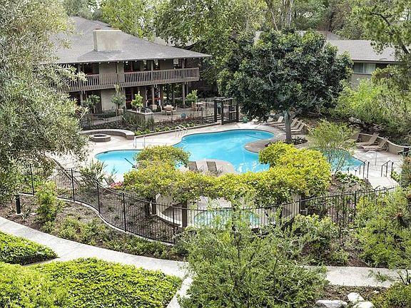 an aerial view of the backyard of a house with a swimming pool