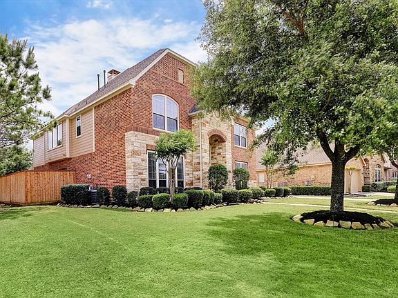 Perry Homes was the builder for this stone and brick home. Entire wood fence was recently replaced.