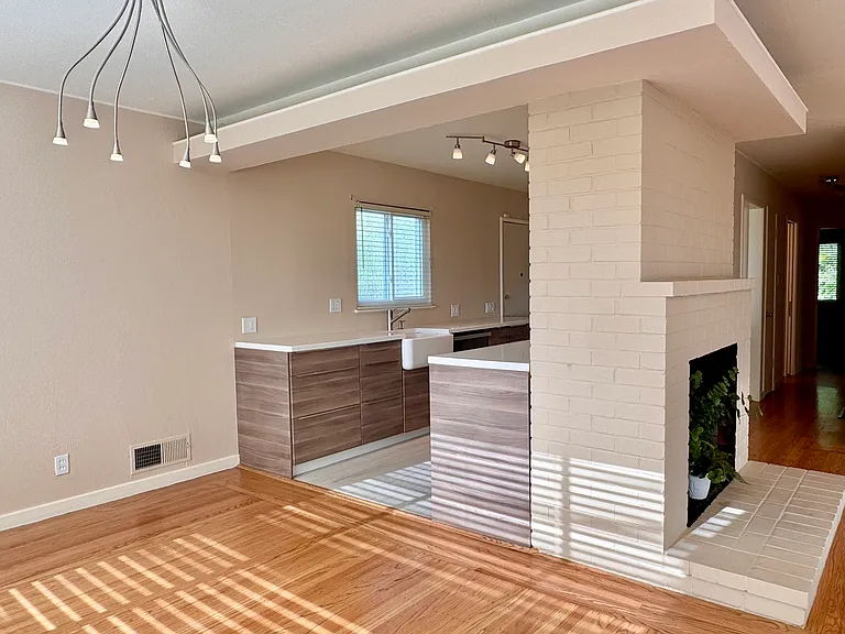The dining area adjoins a modern galley kitchen designed for easy entertaining.