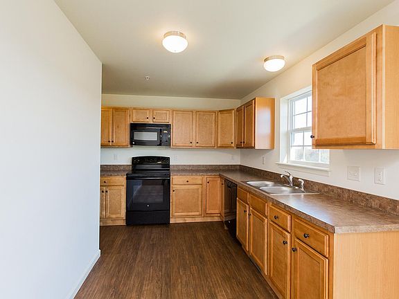 Kitchen is L shaped and goes to left.