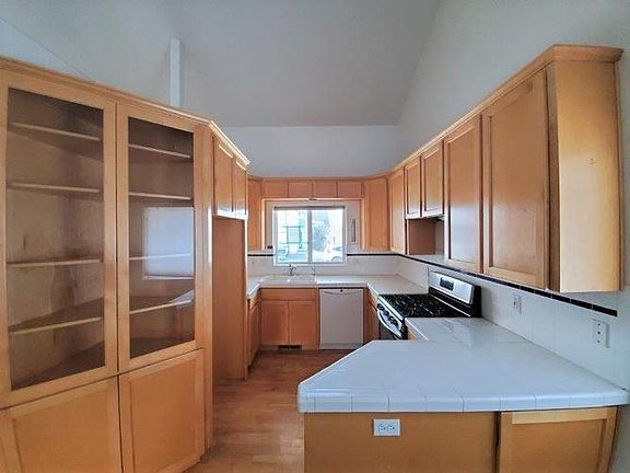 Kitchen with wood floors and built in hutch.