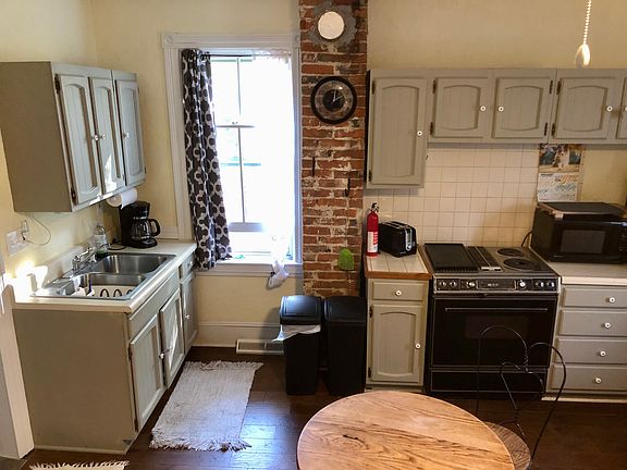 Full kitchen with spices and pots pans and dishes