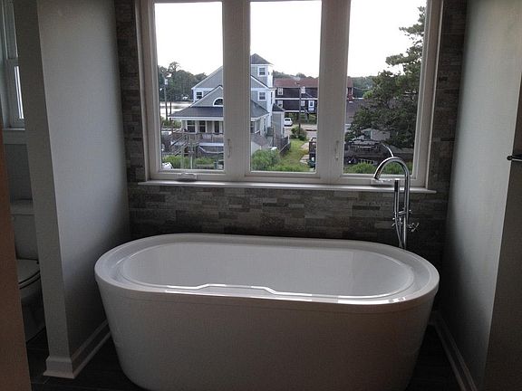 Luxurious aster bath features infinity tub, waterfall shower, dual sinks